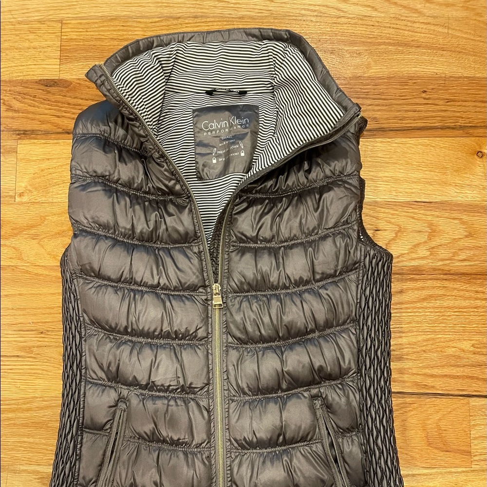 Calvin Klein performance vest. Premium down. Zip secure pocket.